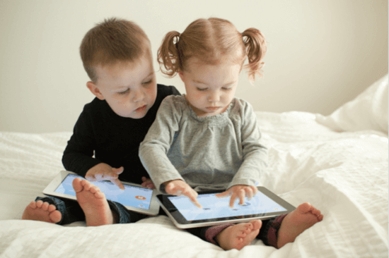 Kids with gadgets. little children holding and playing with