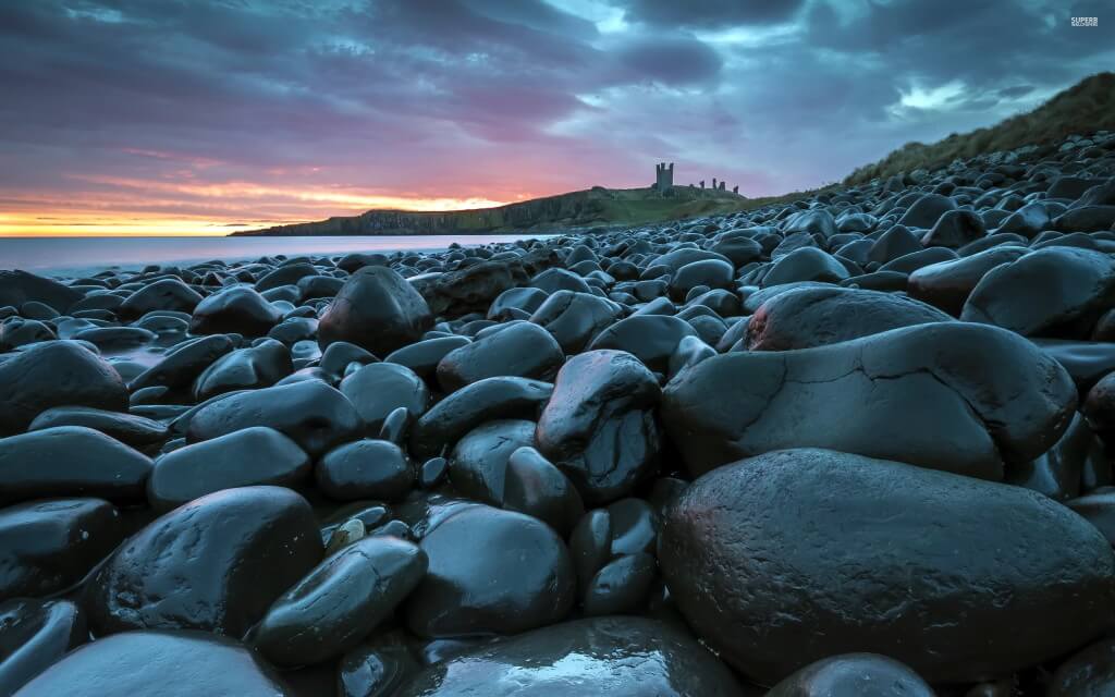 wet stones on the coast at sunset 